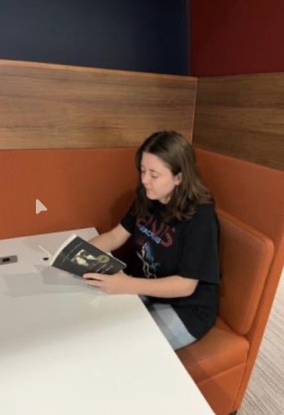 Junior Grace Gamblin reads a book in the IUK Library 